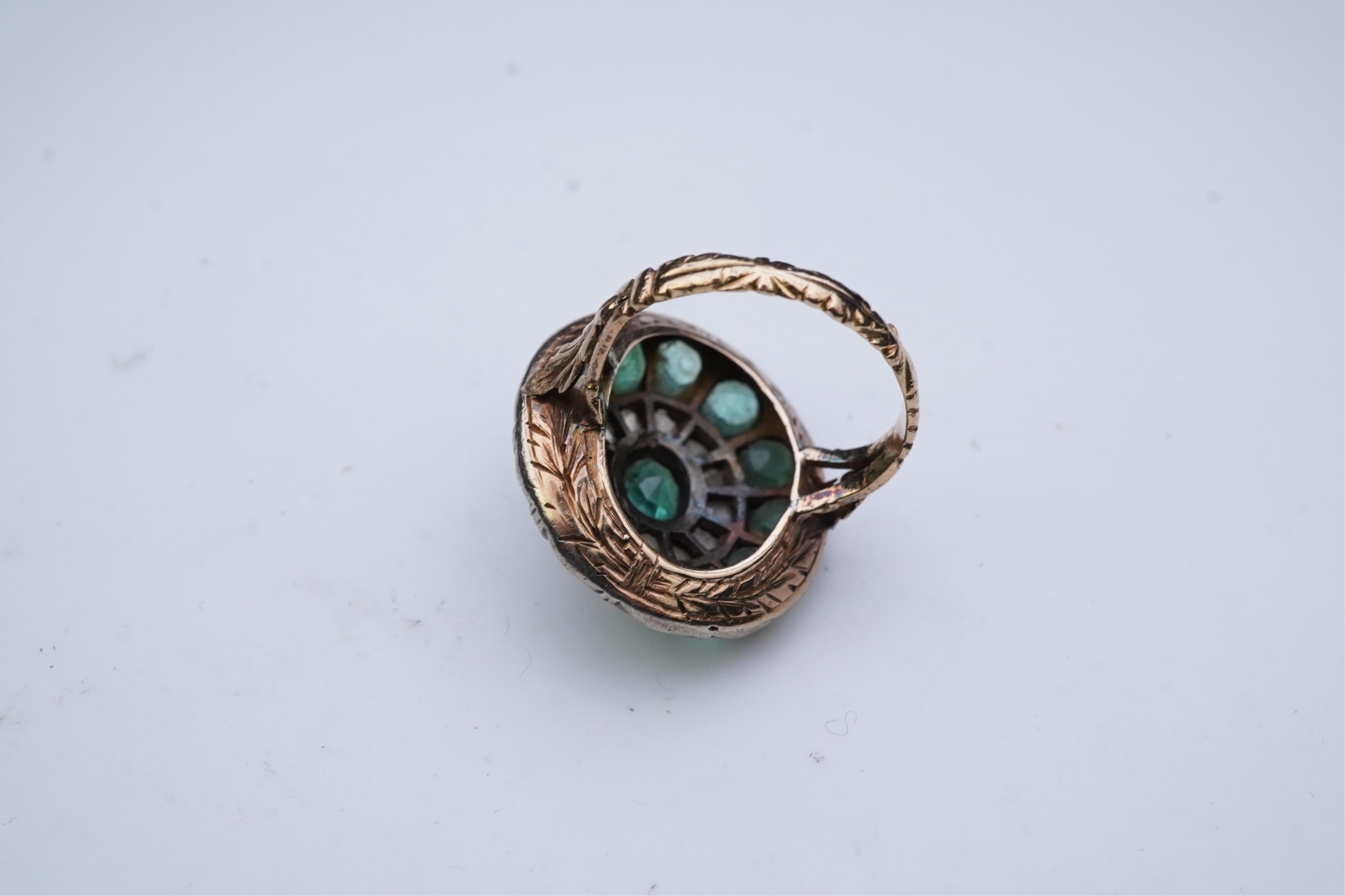 An emerald and diamond ring